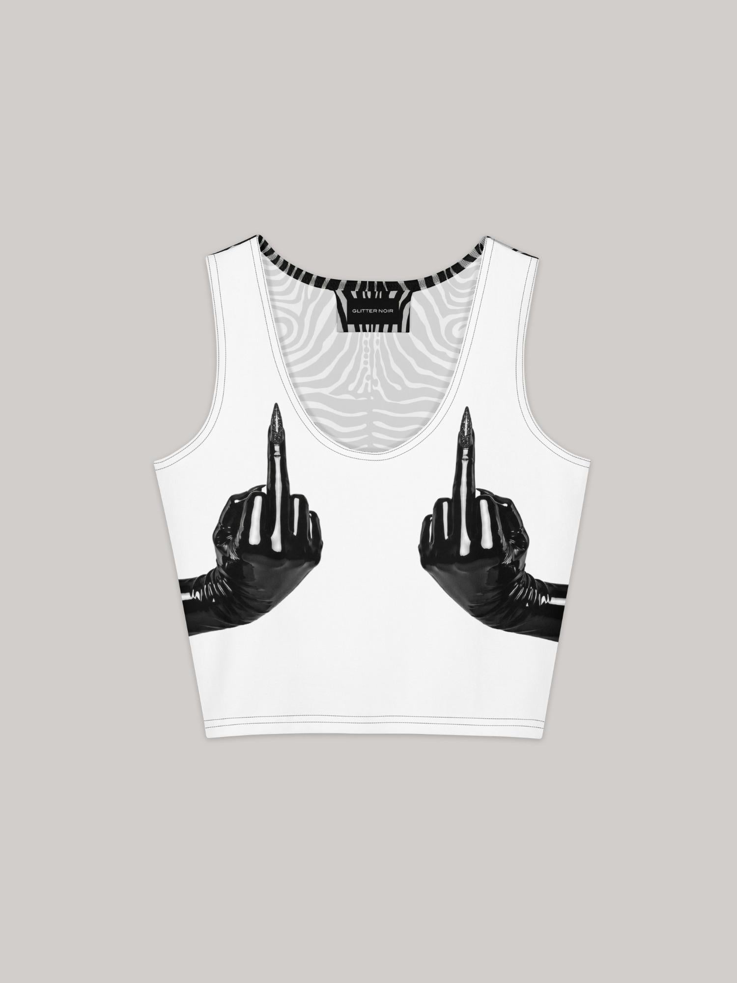 White sleeveless crop top with all-over print graphic featuring two black latex-gloved hands extending middle fingers with pointed stiletto nails, positioned at chest level. Black and white swirling zebra-pattern lining visible at neckline and armhole trim. Glitter Noir branded label at interior neckline. Ghost flat lay on white background.